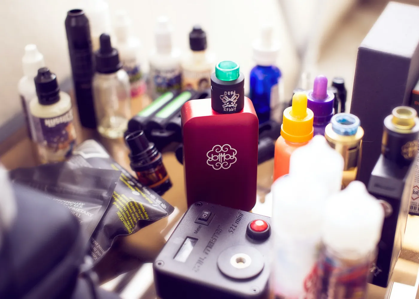 Vape devices and bottles on a bench